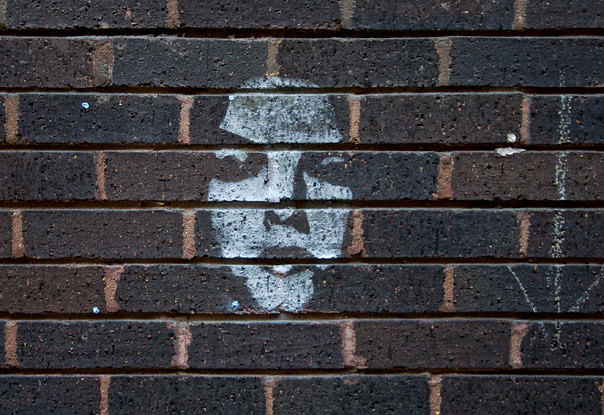Face in the wall stenciled grafitti, Hanbury Street, December 2003